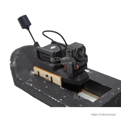 Servo gimbal mounted on foam platform, front-right angle with camera lens and antenna