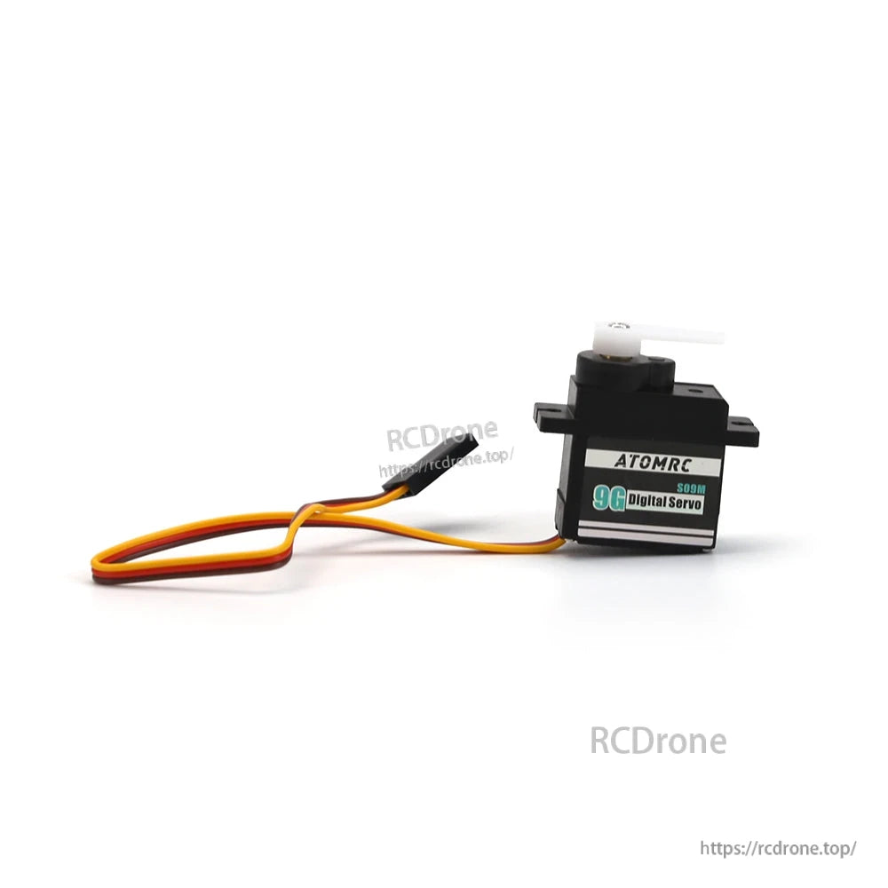 Profile view of ATOMRC servo showing label, mounting tabs, and installed white servo horn