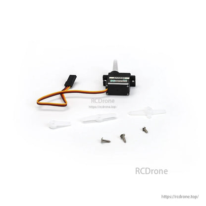 Servo kit layout with installed horn, extra white servo horns and mounting screws spread out