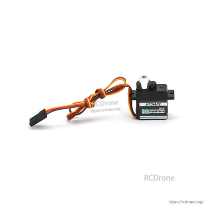 Servo with cable tied in loop and white horn installed, label side facing camera