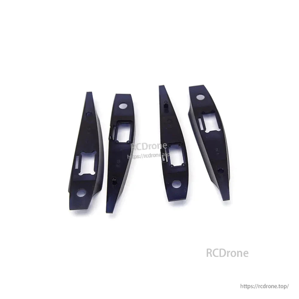 Four black mounting brackets with rectangular cutouts for internal fuselage/wing hardware