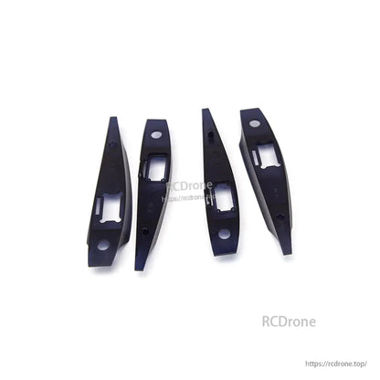 Four black mounting brackets with rectangular cutouts for internal fuselage/wing hardware