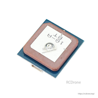 GPS module close-up on blue circuit board with ceramic antenna patch