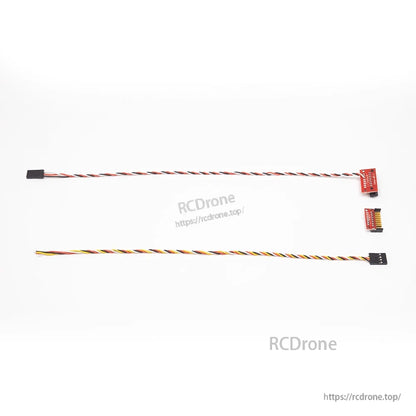 Two long servo extension cables with connectors and small red adapter board for RC plane wiring