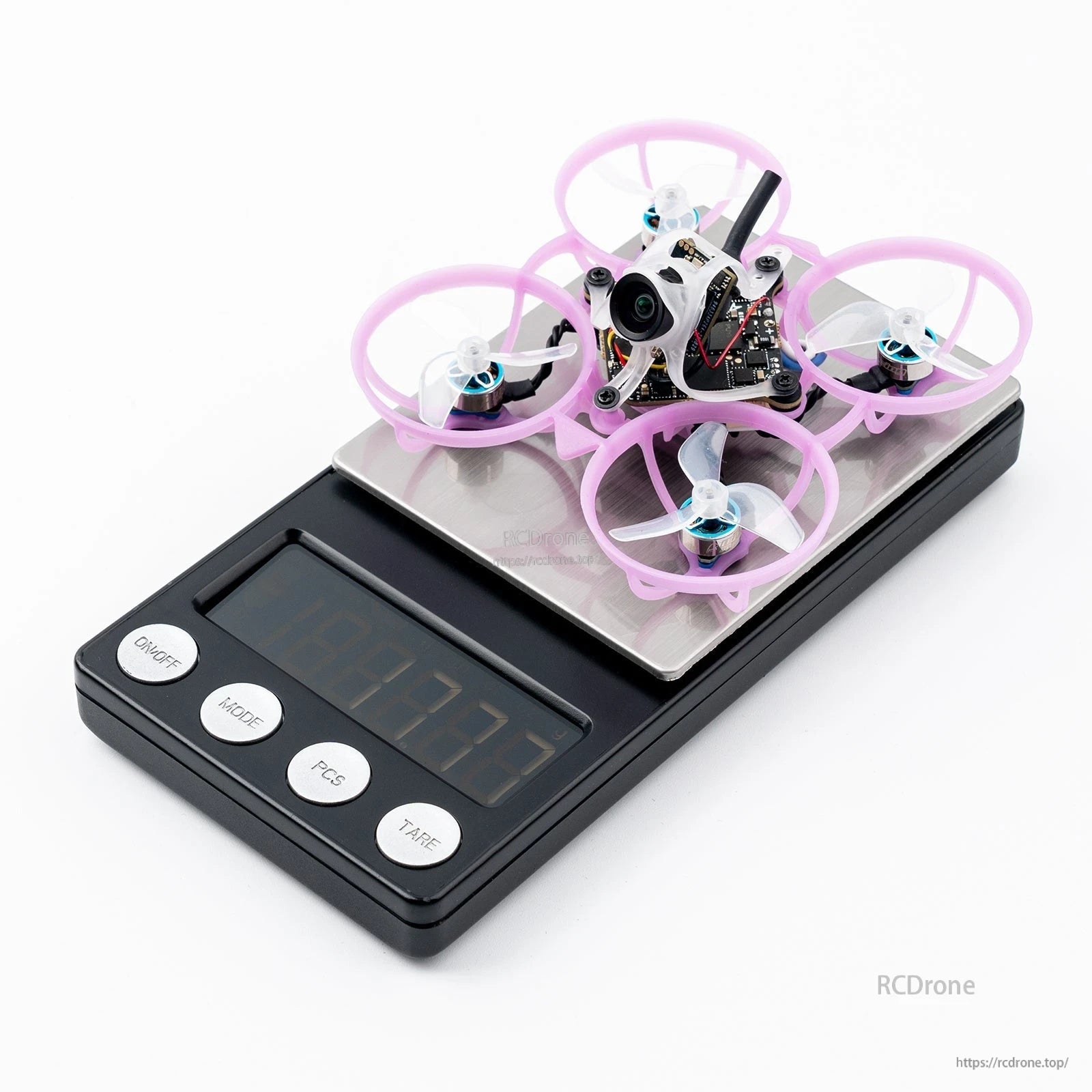 BETAFPV micro FPV whoop drone with pink prop guards sitting on a digital scale for weight check