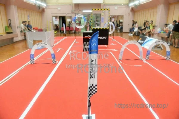 Indoor FPV Whoop course with BETAFPV arch gates set on a gym floor for practice and racing