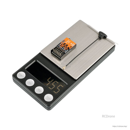 Micro receiver on digital scale showing 4.5 g weight, with antenna placed beside it