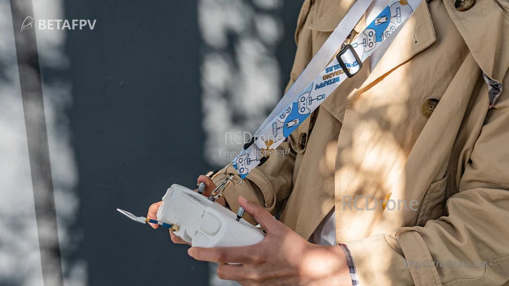 BETAFPV LiteRadio transmitter neck strap in white print, worn crossbody with an FPV radio controller