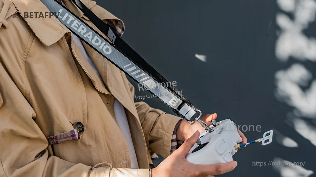 Reflective black LITERADIO neck strap connected to a LiteRadio transmitter, worn over the shoulder