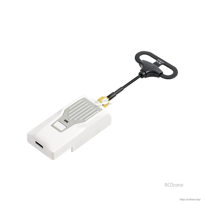 Loop antenna attached to a white radio transmitter module with SMA connector, antenna positioned off to the side