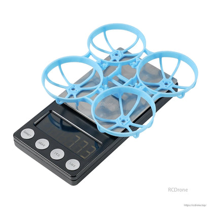 Meteor75 Pro whoop frame on digital scale showing 7.73g weight reading