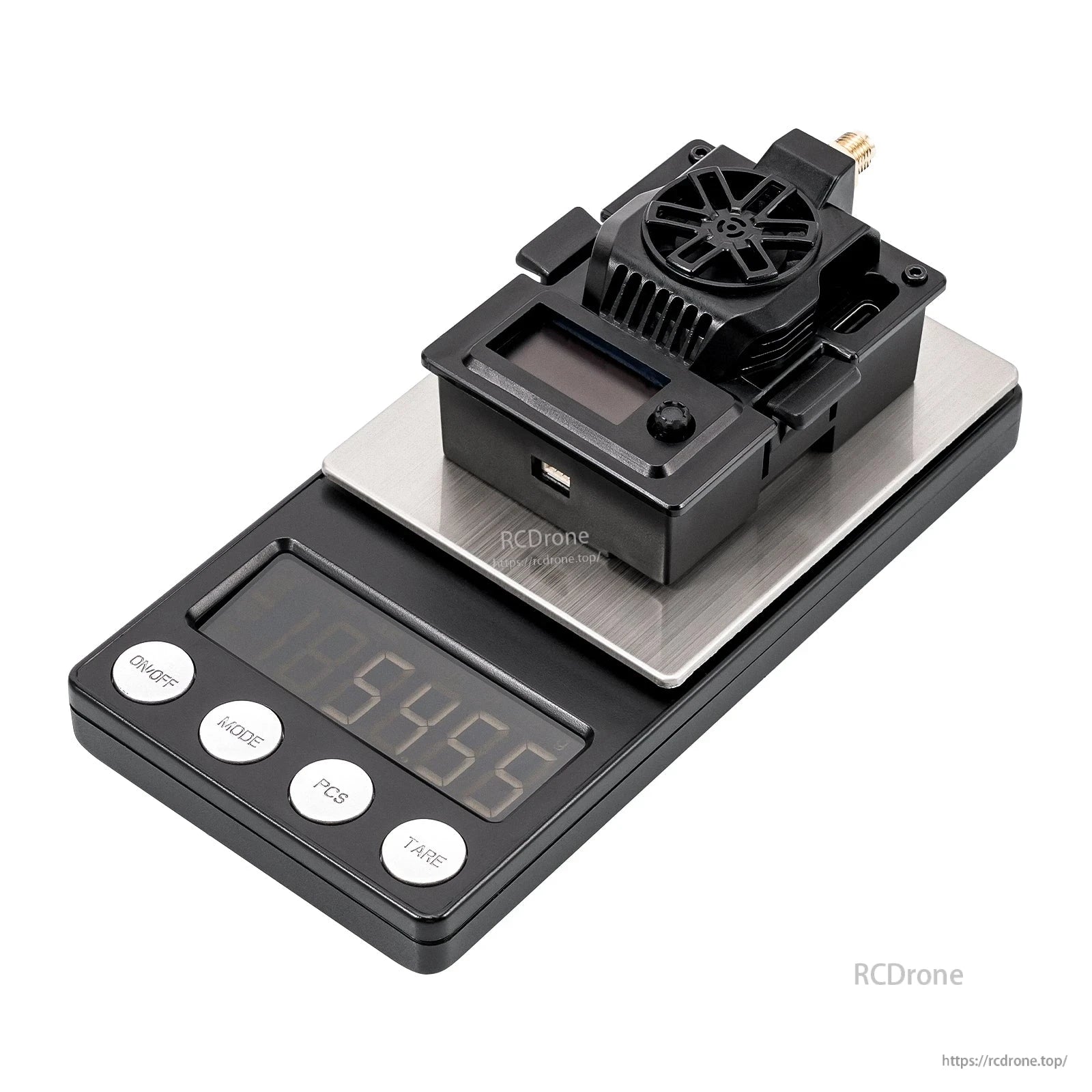 Micro TX V2 transmitter module on a digital scale showing weight measurement