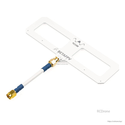 Angled view of white Moxon panel antenna labeled 915M with white coax lead attached