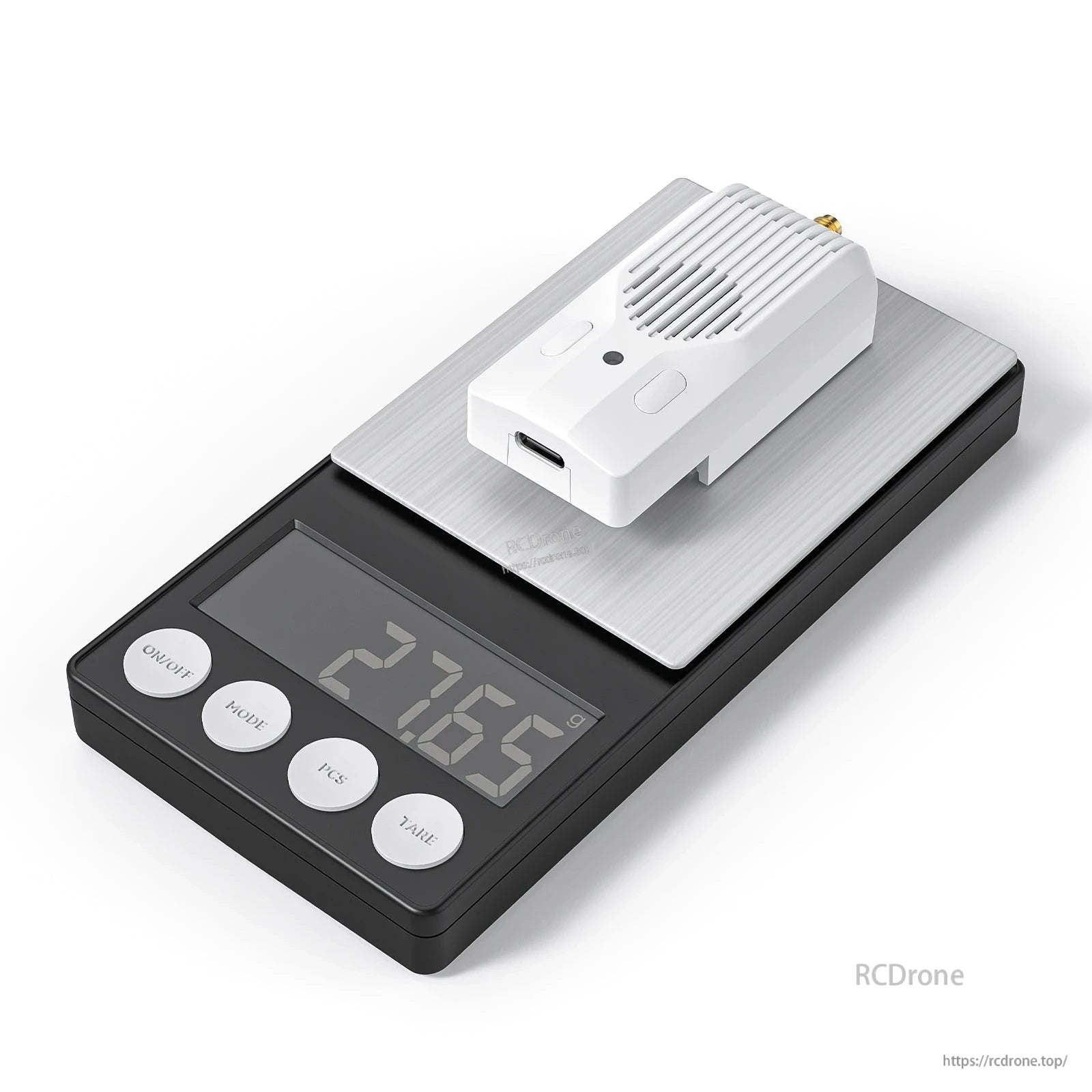 Module resting on a digital scale, showing weight readout on the display
