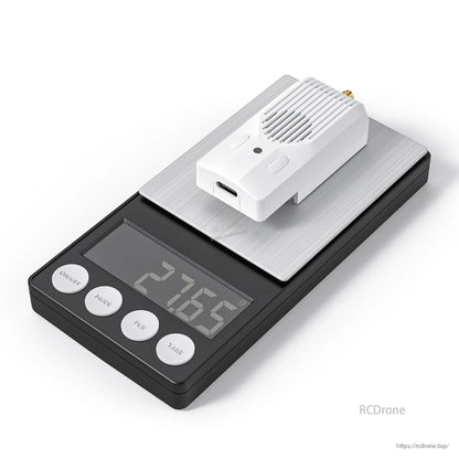 Module resting on a digital scale, showing weight readout on the display