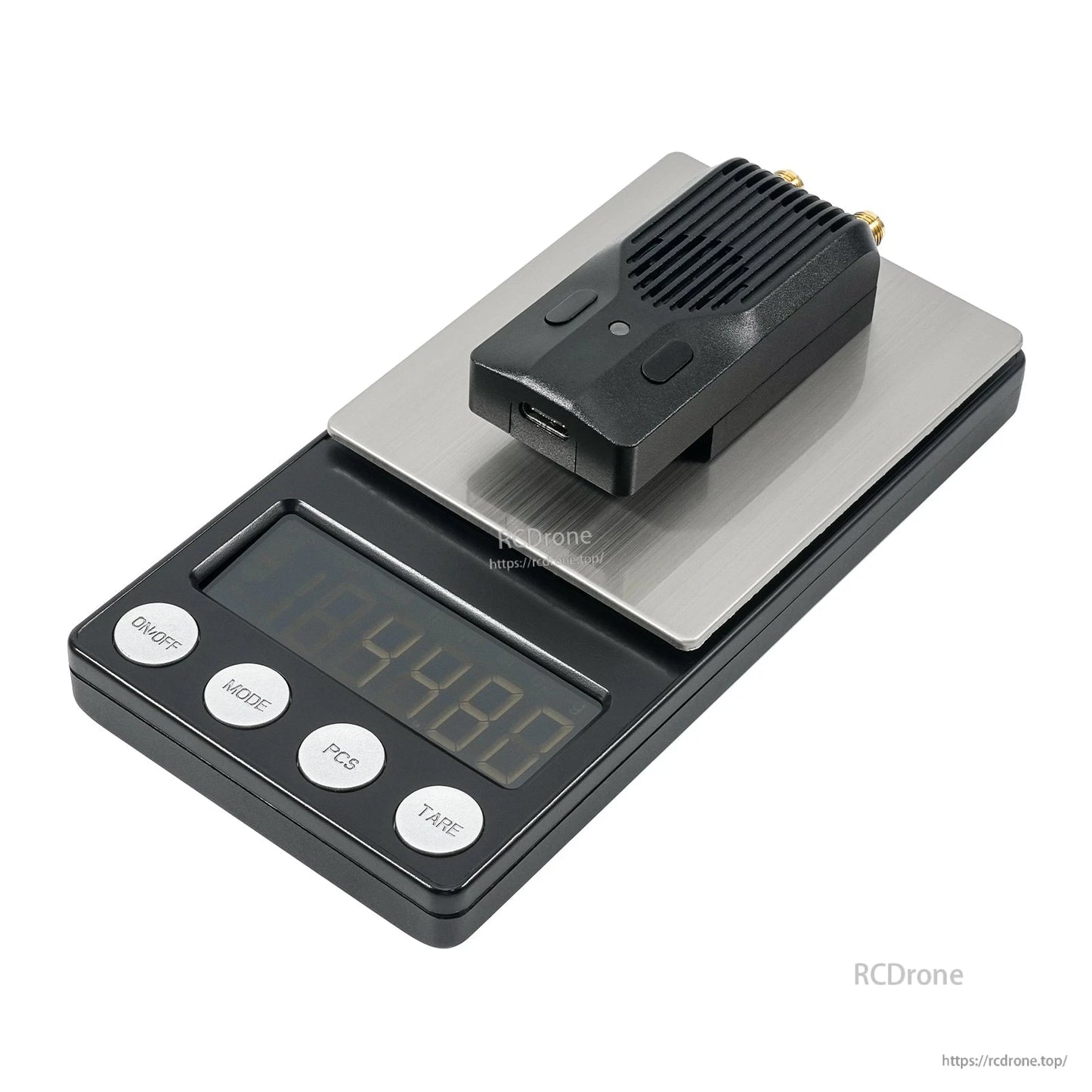 Module placed on a digital scale platform to show compact size and weight reference