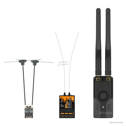 Transmitter module shown alongside two small receiver boards with antennas for size comparison