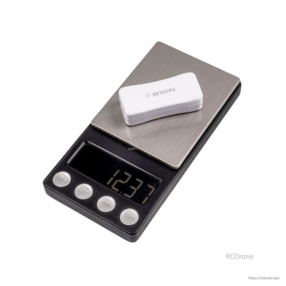 Charger shown on digital scale with weight reading 12.31 g