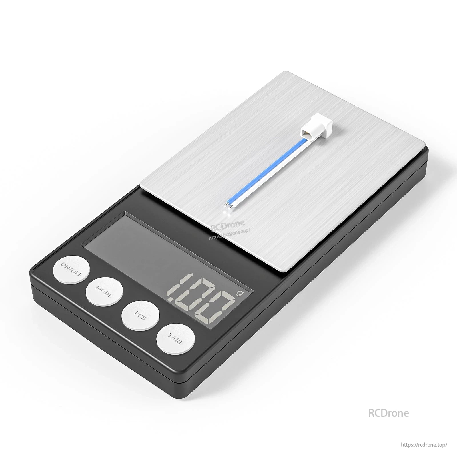 on digital scale showing 1.02 g weight, white plug with short leads