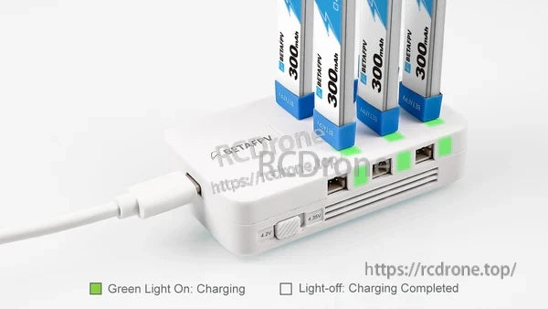 Six 1S batteries charging on the 6-port charger with green per-port LED status indicators