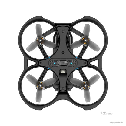 Top view of a BetaFPV ducted micro quadcopter (whoop) with black frame and four tri-blade propellers