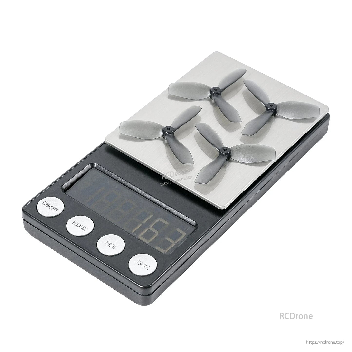 Four grey three-blade propellers placed on a digital scale, showing weighing setup