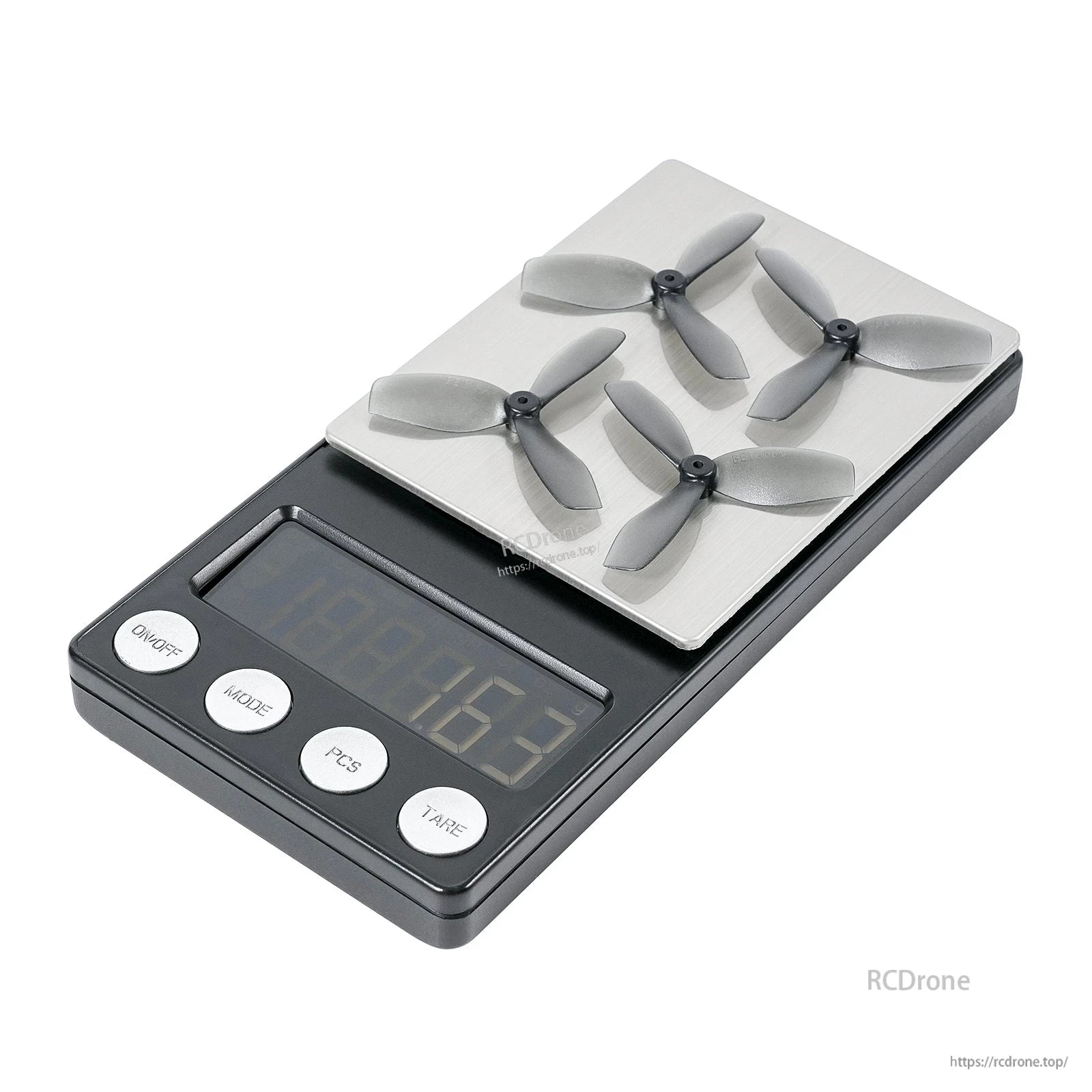 Four grey three-blade propellers placed on a digital scale, showing weighing setup