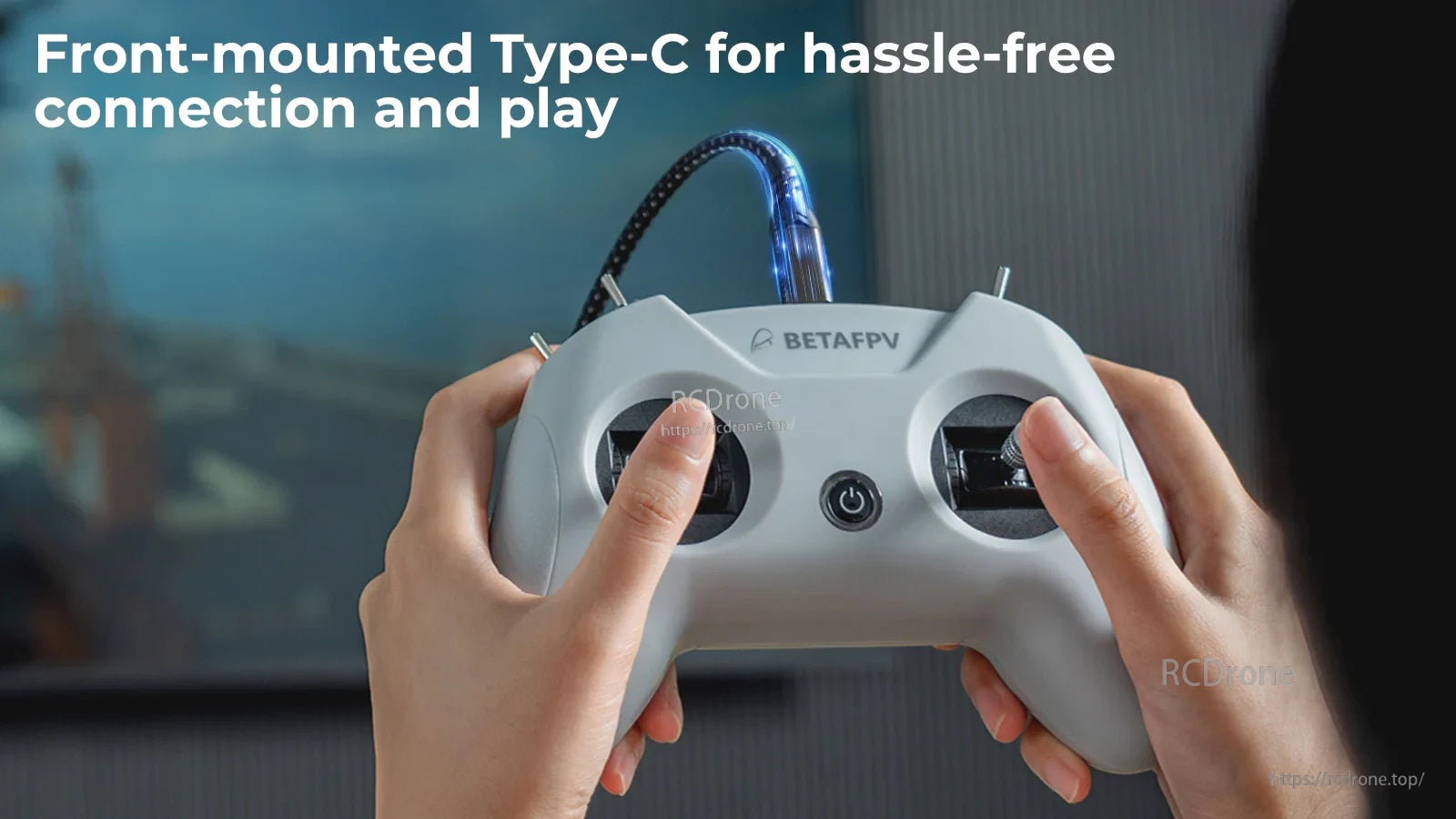 Hands holding BetaFPV LiteRadio 2 SIM Controller with front-mounted USB Type-C cable connected