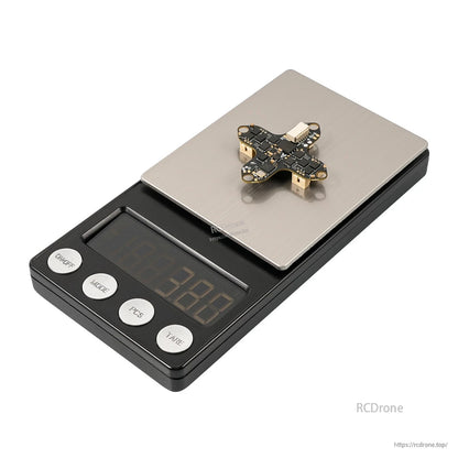 Matrix 1S flight controller on a digital scale for weight reference, angled view on metal platform