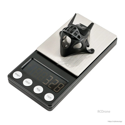 Black micro FPV canopy on digital scale, weight display reading 3.28
