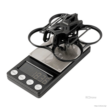 BetaFPV Pavo Femto 75mm whoop frame assembled on digital scale with PA12 ducts and top cage