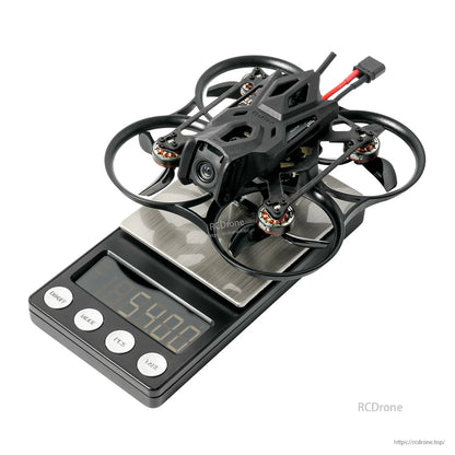 BetaFPV micro FPV whoop drone with ducted prop guards on a digital scale reading 54.02 g