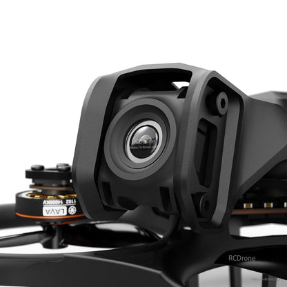 Close-up of a BetaFPV FPV camera mounted in a protective bracket on a small drone frame