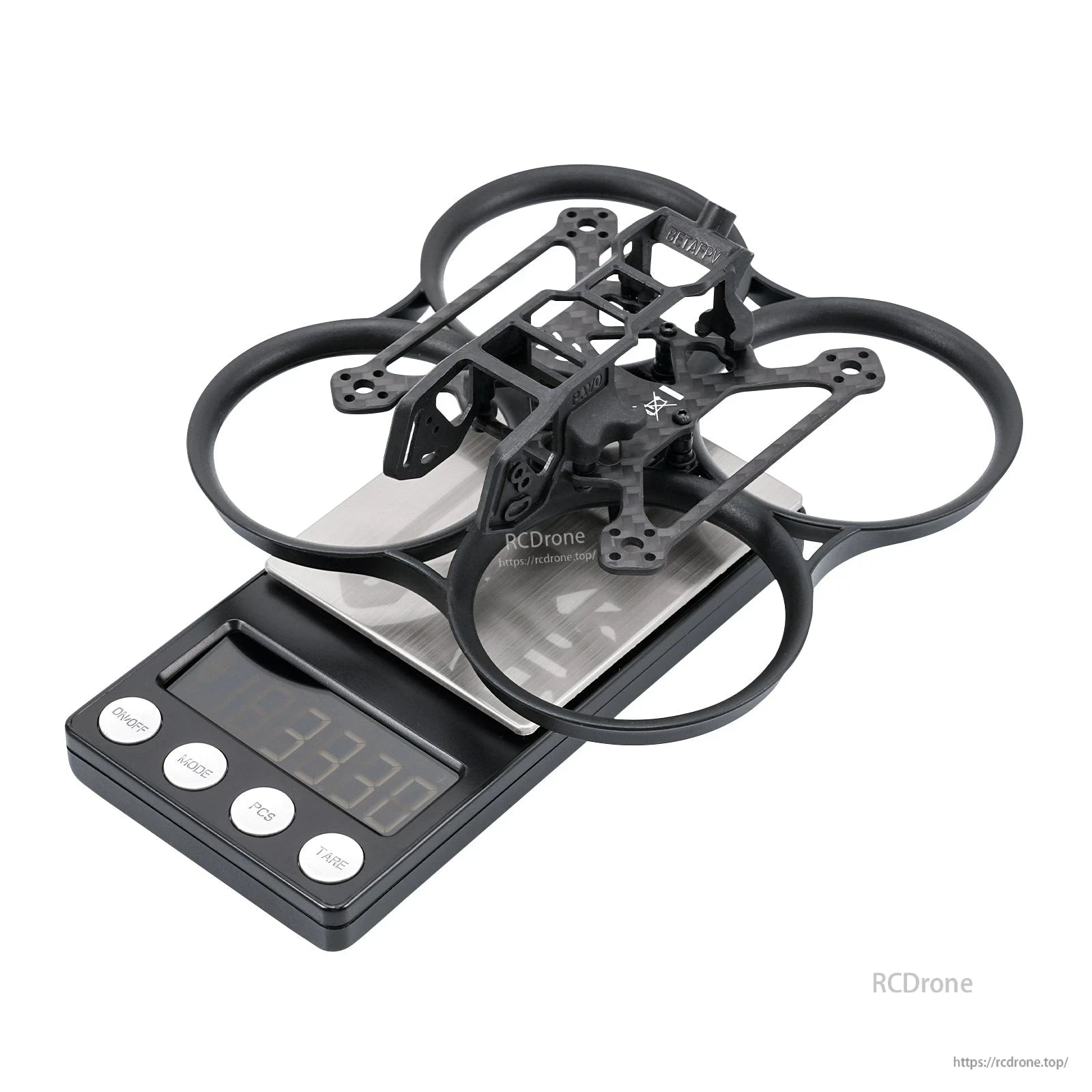 Black whoop frame on digital scale showing weight 33.7 g, angled top view