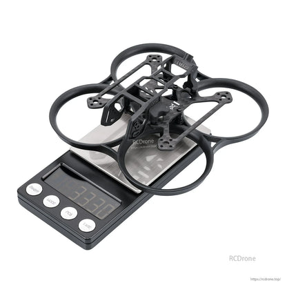 Black whoop frame on digital scale showing weight 33.7 g, angled top view
