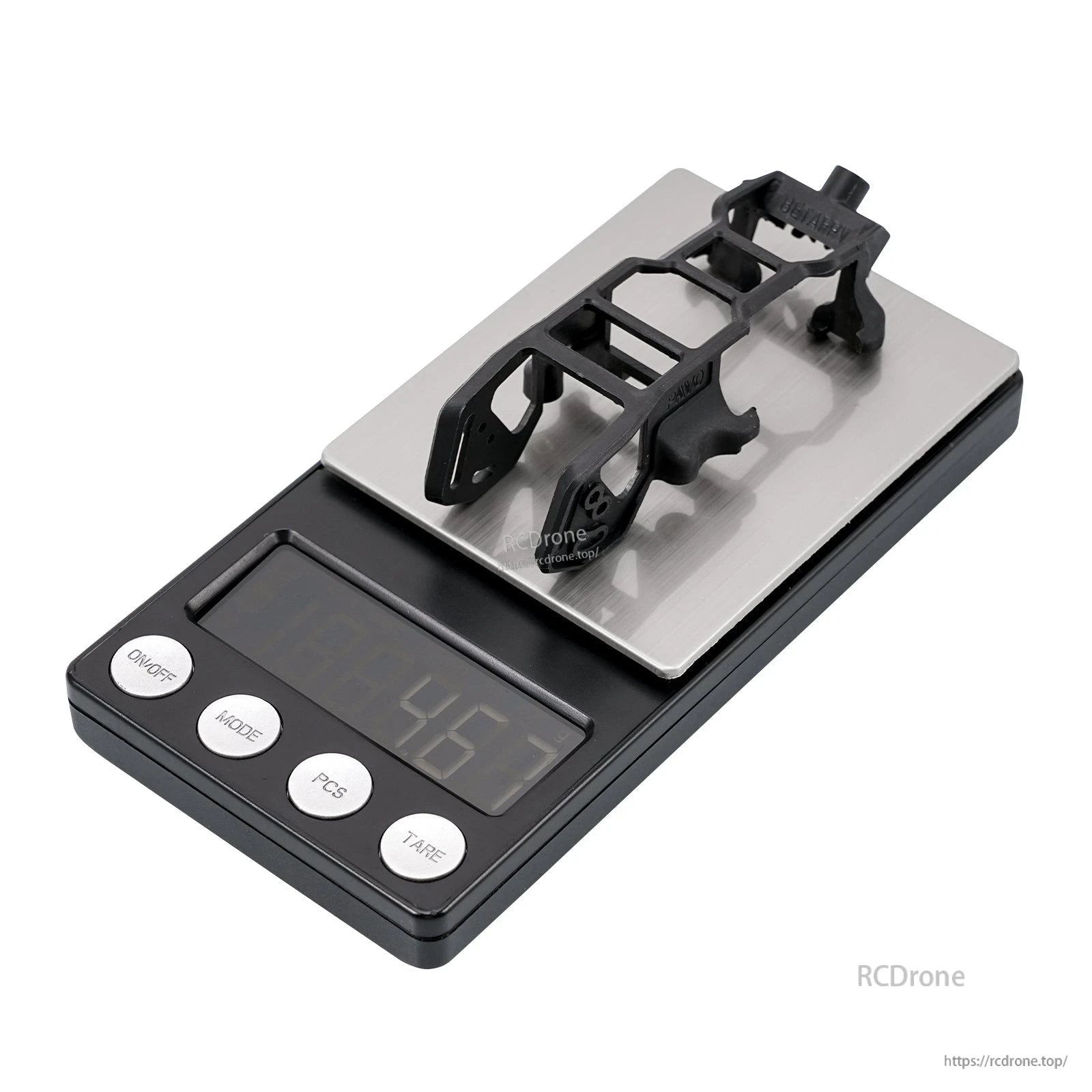 Black camera canopy bracket on scale showing 4.6 g weight, angled view