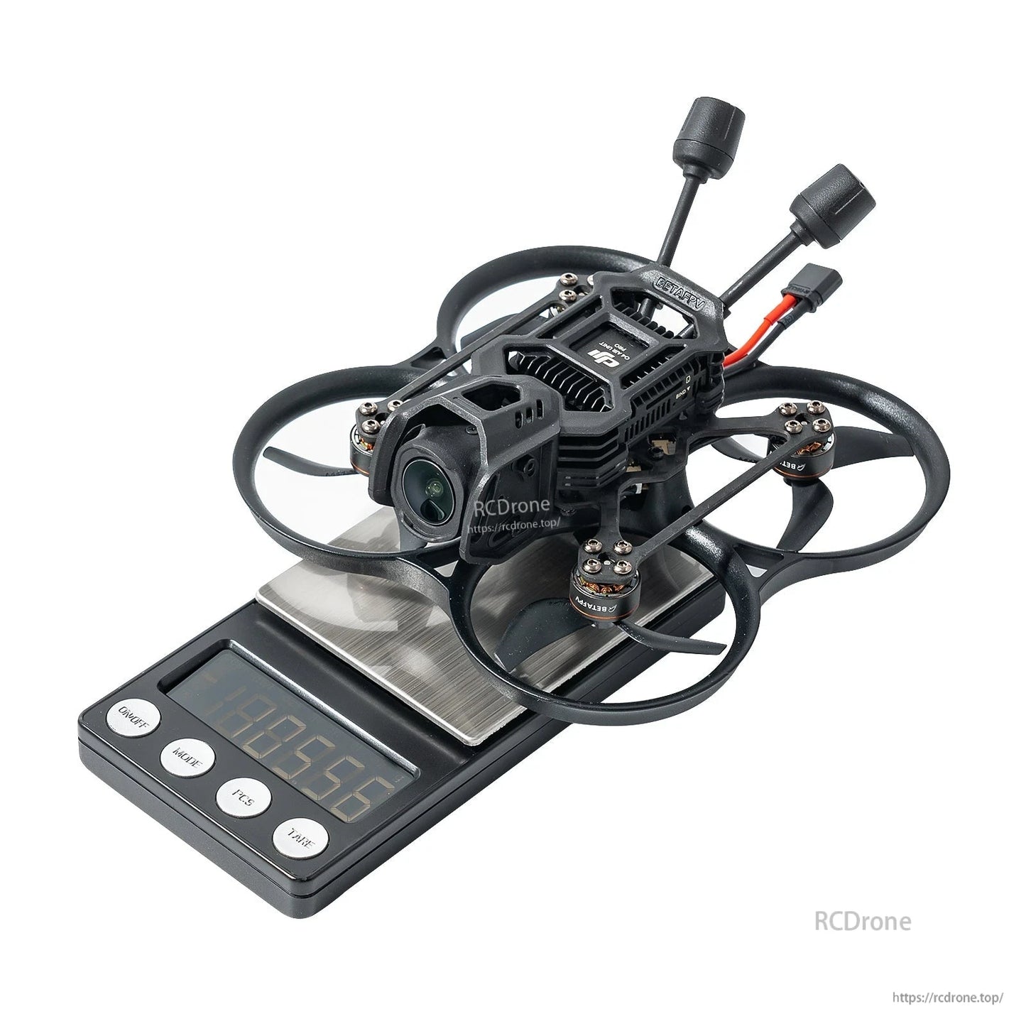 BetaFPV, Small ducted FPV cinewhoop drone with front camera and dual antennas sitting on a digital scale reading 105.56 g