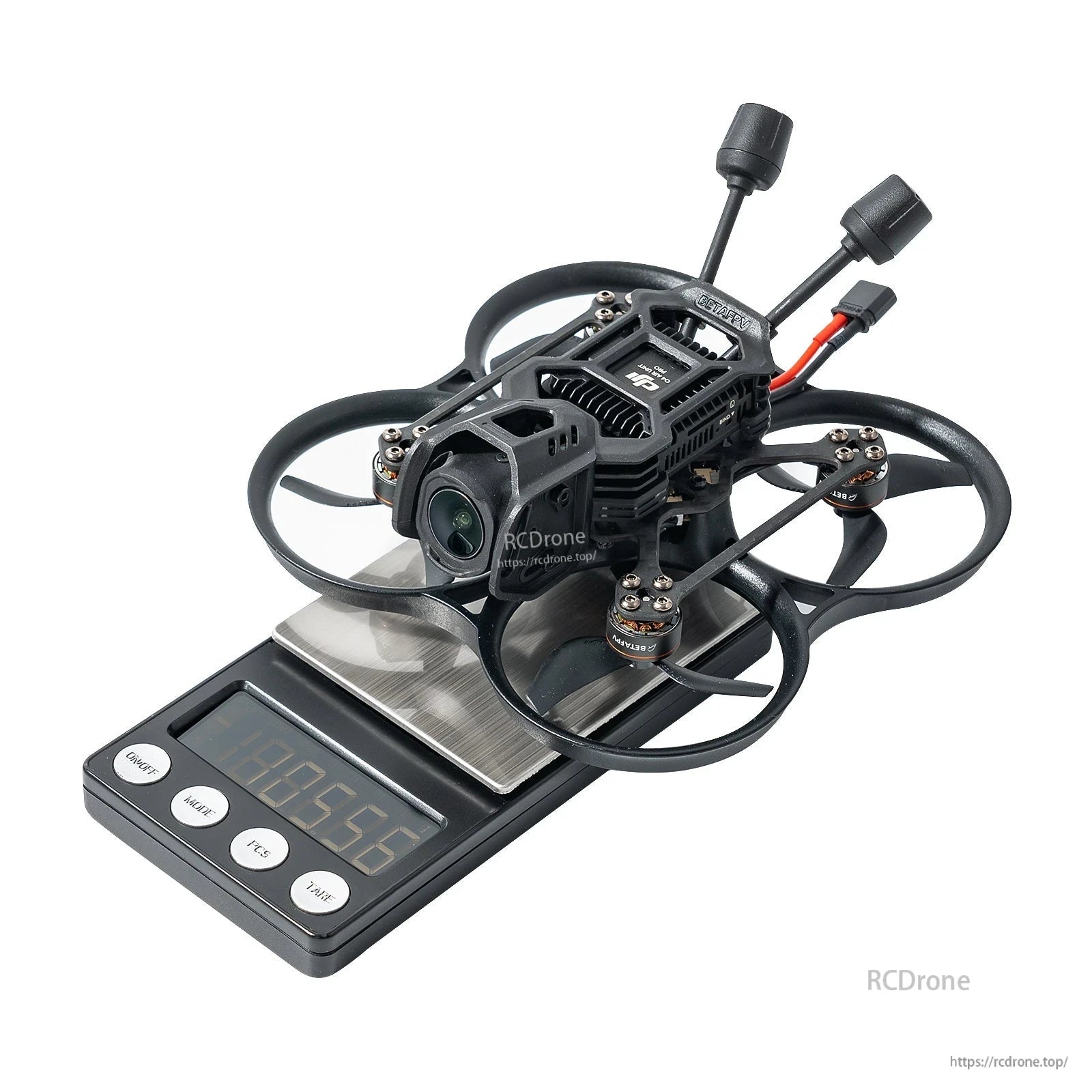BetaFPV, Small ducted FPV cinewhoop drone with front camera and dual antennas sitting on a digital scale reading 105.56 g