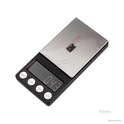 Micro receiver module on digital scale showing 0.43 g weight