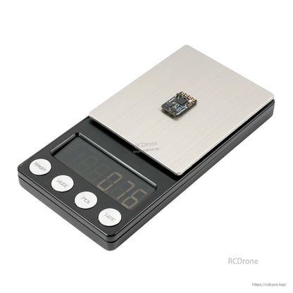 Compact receiver board on digital scale showing lightweight measurement display