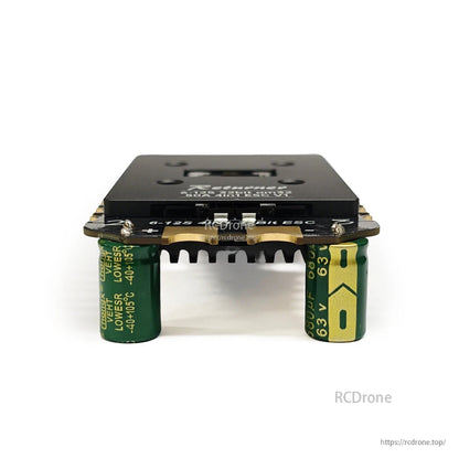 BrotherHobby Returner 4-in-1 drone ESC with top heatsink and dual 2200µF 63V capacitors underneath