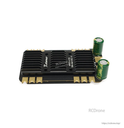 BrotherHobby Returner 4-in-1 drone ESC with black heatsink and two green electrolytic capacitors