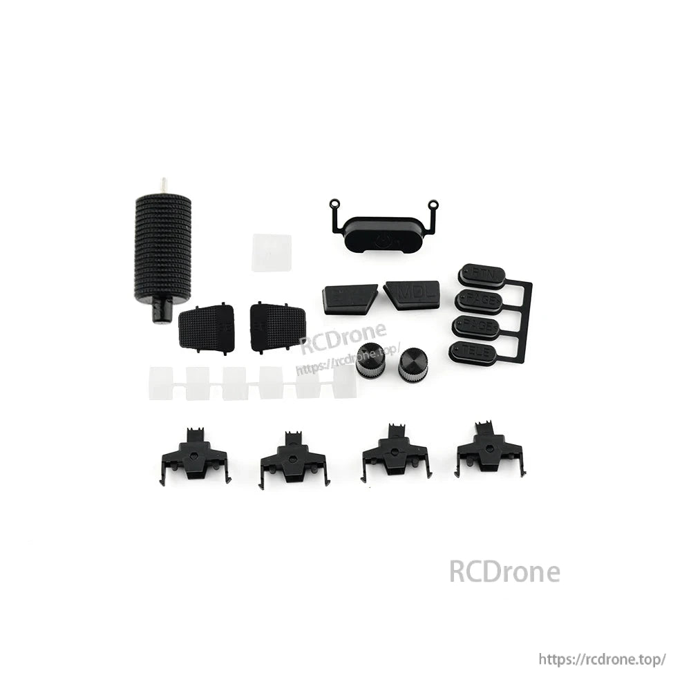 Replacement button set and small plastic parts laid out for a radio controller, assorted pads and caps