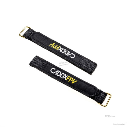 Two black hook-and-loop straps overlapped, showing CADDXFPV logo panels and gold buckles