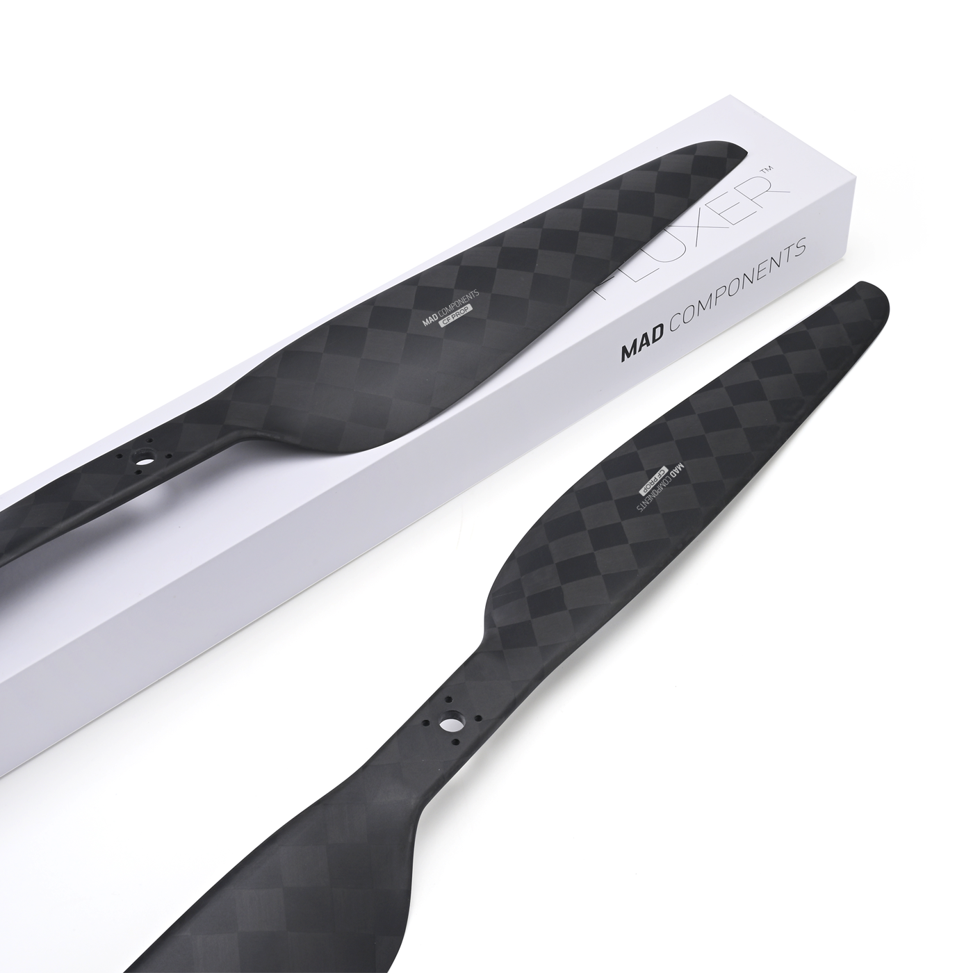 MAD CB2 PRO 26x8.5in Carbon Fiber Propeller, MAD CB2 PRO carbon fiber propeller blades with checker-weave finish beside MAD Components box