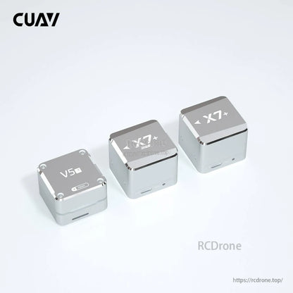 CUAV X7+ core flight controller module in silver metal case, shown alongside CUAV X7 and V5+ units