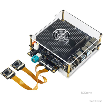 Close-up of RDK S100 system with camera expansion board under acrylic case, two MIPI camera modules attached by ribbon cables