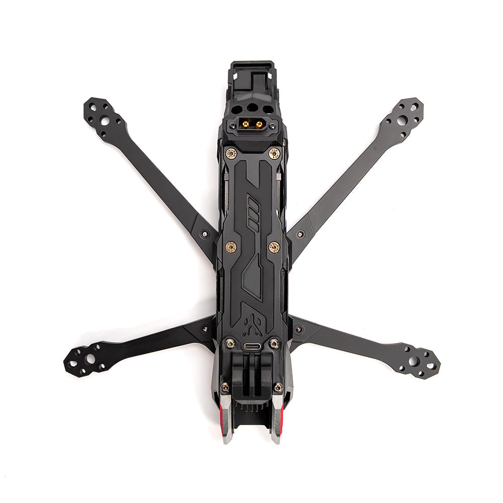 Top-down view of assembled FPV drone frame showing four arms, center plate, and front camera mount area