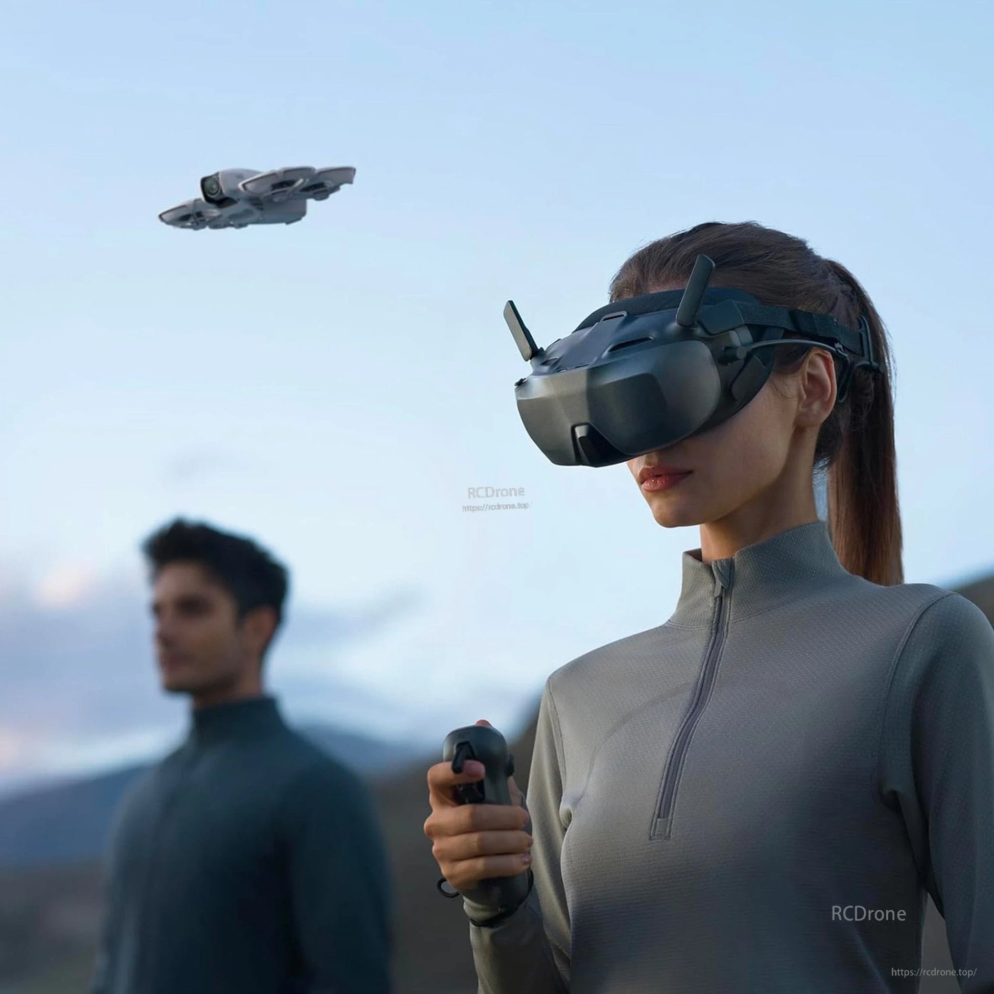 DJI Goggle, Person wearing DJI FPV goggles with antennas while holding a controller as a drone flies overhead