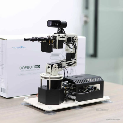 DOFBOT Pro robotic arm on base with depth camera, shown next to product box in a clean desktop scene